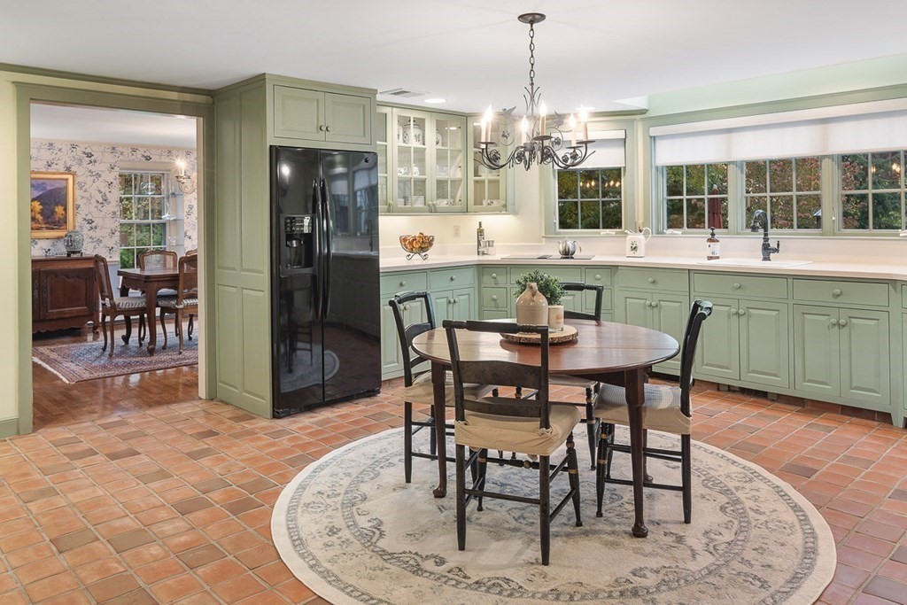 34 Barretts Mill Road Concord, MA 01742 - Photo 10 of 40 a dining area with granite countertop a table chairs and a chandelier