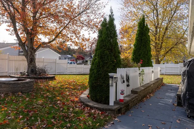 a white house that has tree in front of it