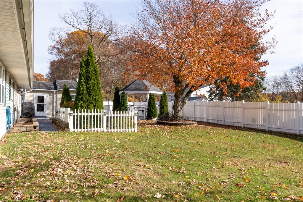81 Dixon Road Brockton, MA 02302 - Photo 15 of 42 a view of a house with a small yard and wooden fence