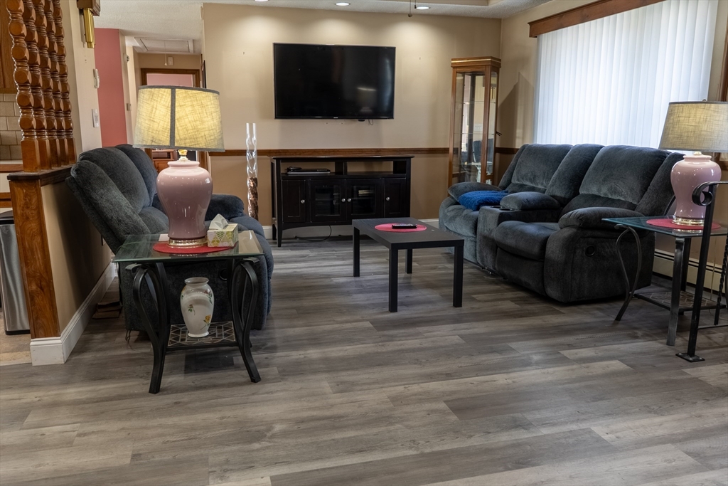 81 Dixon Road Brockton, MA 02302 - Photo 2 of 42 a living room with furniture a fireplace and a flat screen tv