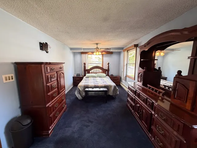 a bedroom with a bed and a lamp