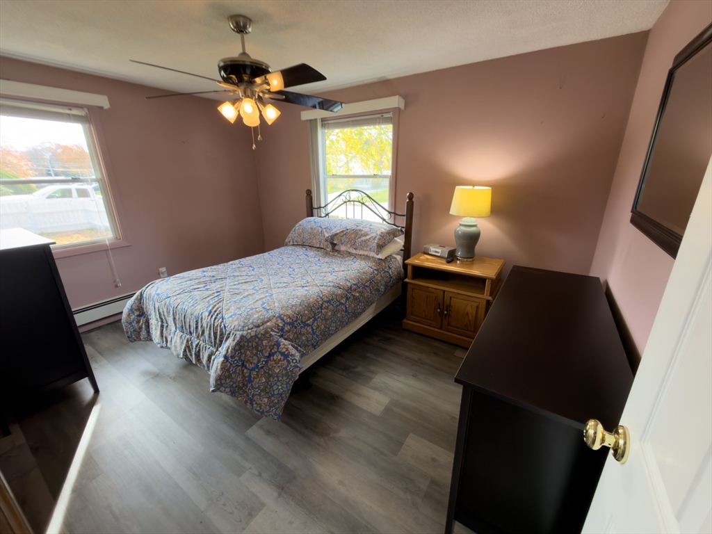 81 Dixon Road Brockton, MA 02302 - Photo 32 of 42 a bedroom with a bed and a lamp