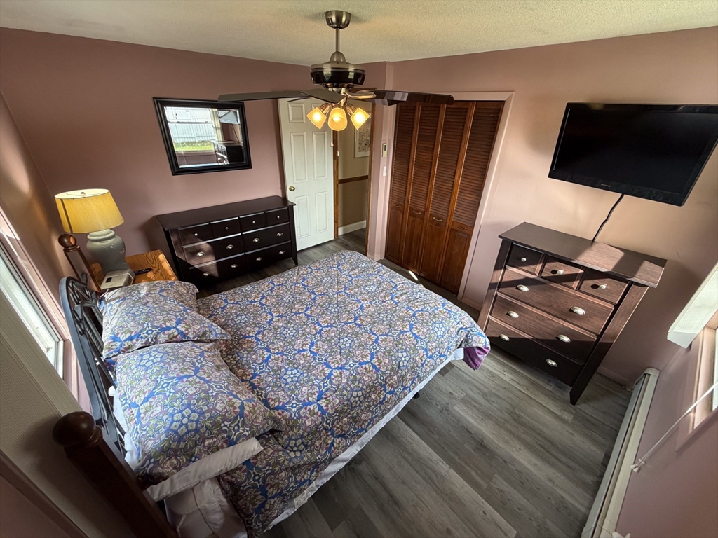 81 Dixon Road Brockton, MA 02302 - Photo 33 of 42 a bedroom with a bed dresser and a flat tv screen