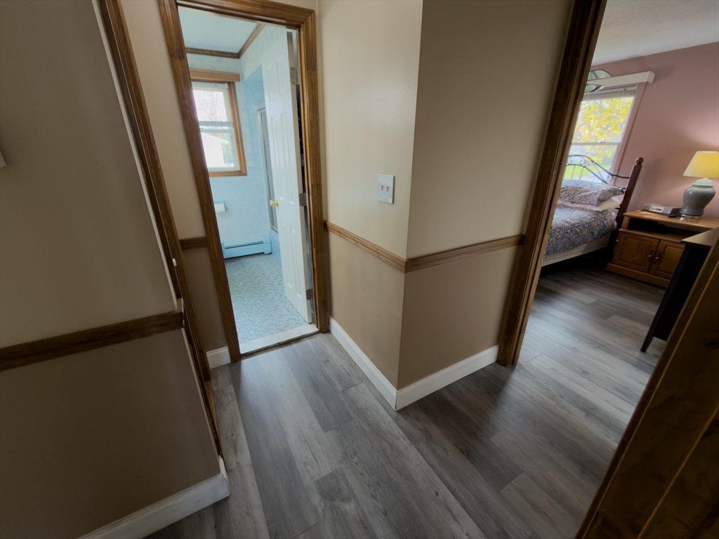 81 Dixon Road Brockton, MA 02302 - Photo 34 of 42 a view of a hallway with wooden floor and stairs