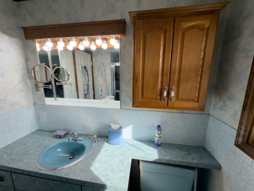 81 Dixon Road Brockton, MA 02302 - Photo 36 of 42 a bathroom with a granite countertop sink and a mirror