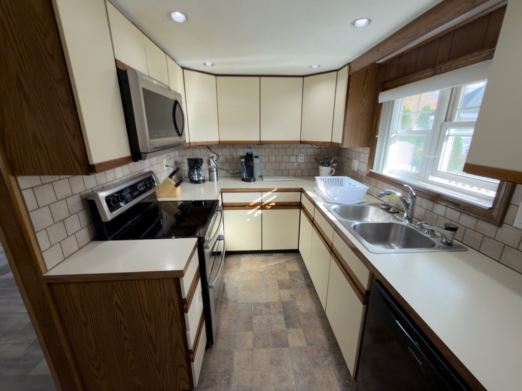 81 Dixon Road Brockton, MA 02302 - Photo 37 of 42 a kitchen with a sink stove and microwave