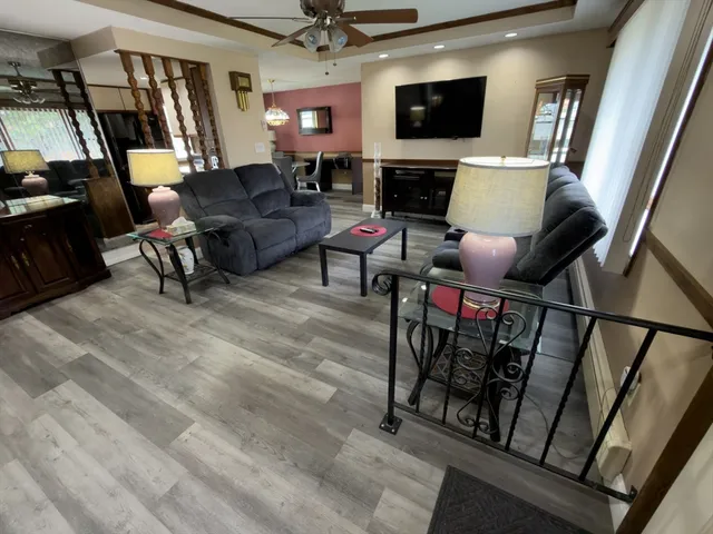 a roof deck with table and chairs and potted plants