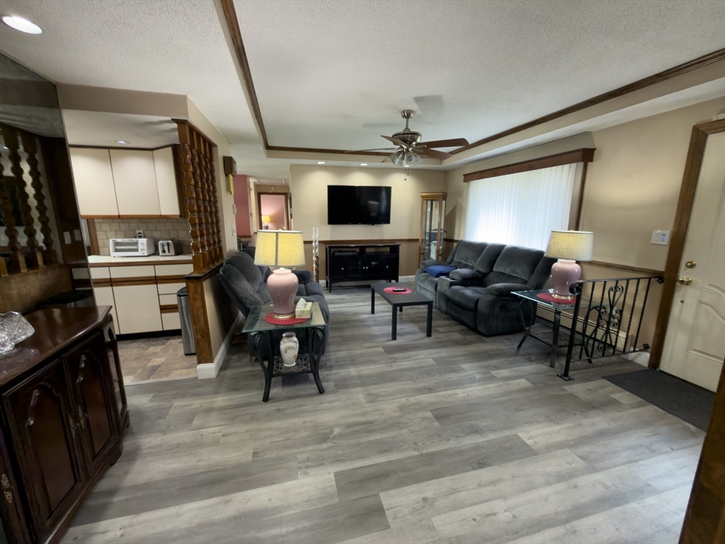 81 Dixon Road Brockton, MA 02302 - Photo 39 of 42 a living room with furniture and a flat screen tv