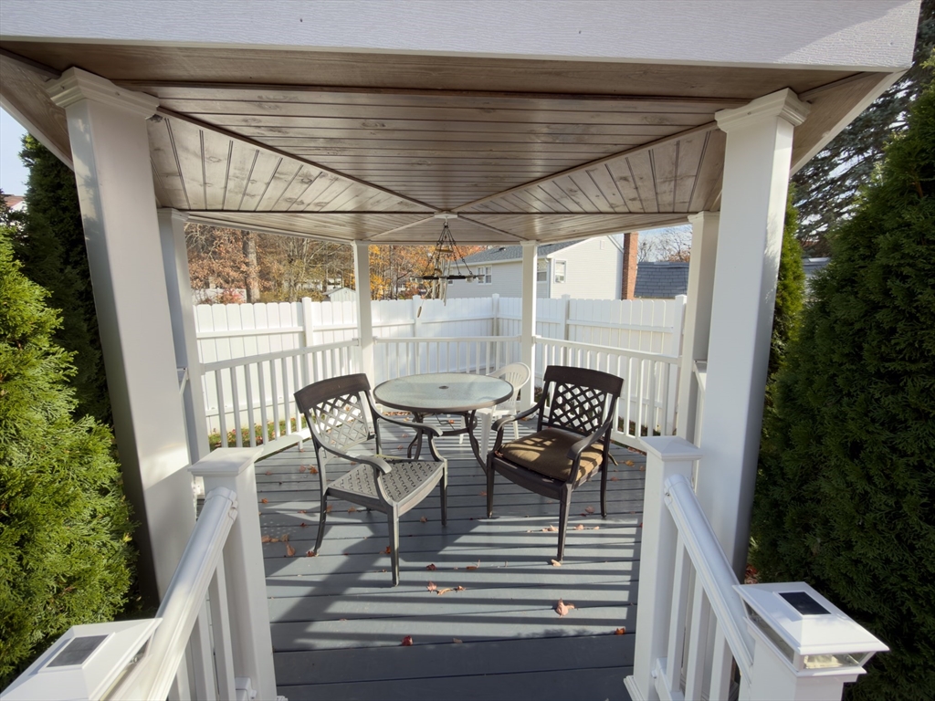 81 Dixon Road Brockton, MA 02302 - Photo 41 of 42 a roof deck with table and chairs and potted plants