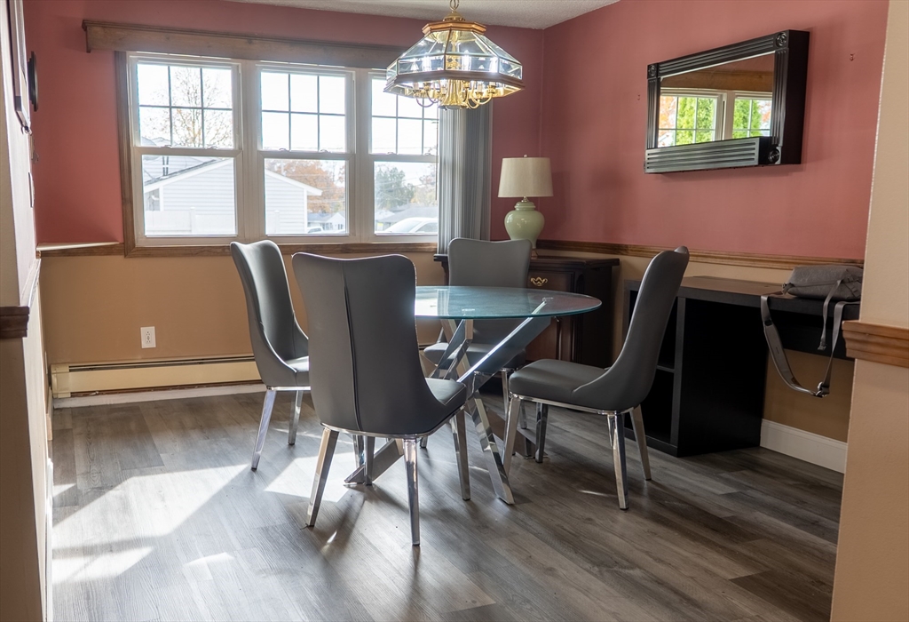 81 Dixon Road Brockton, MA 02302 - Photo 42 of 42 a view of a dining room with furniture a chandelier and wooden floor