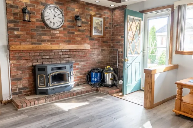 a view of livingroom with furniture a fireplace and wooden floor