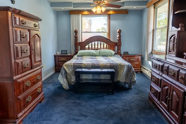 a bed sitting in a room next to a window