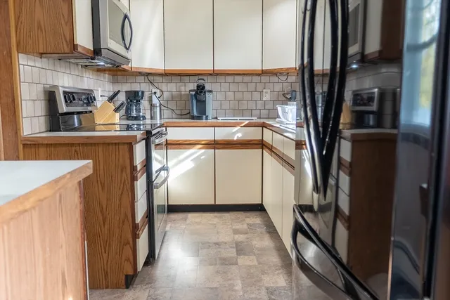 a kitchen with a refrigerator and a sink