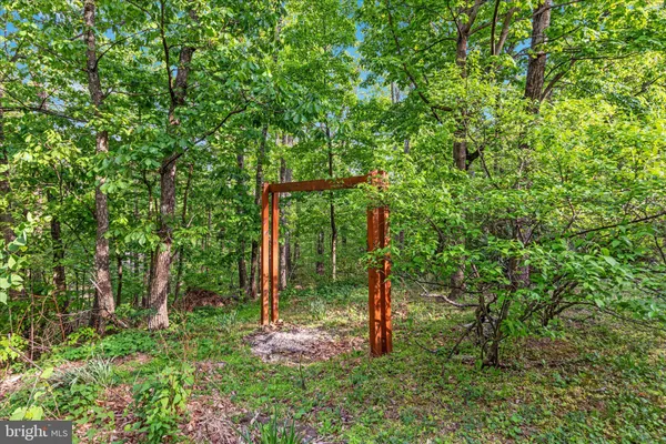 a view of backyard with outdoor seating and green space