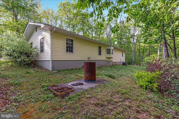 a backyard of a house with wooden floor chairs sofa and barbecue oven
