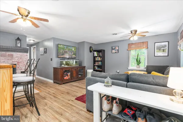 a view of a livingroom with furniture window and wooden floor