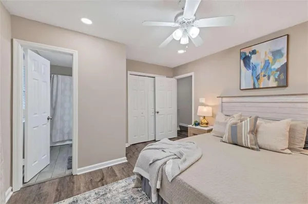a bedroom with a large bed and a chandelier