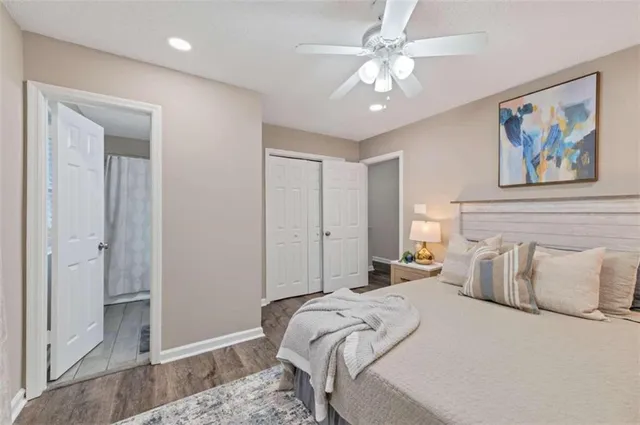 a bedroom with a large bed and a chandelier