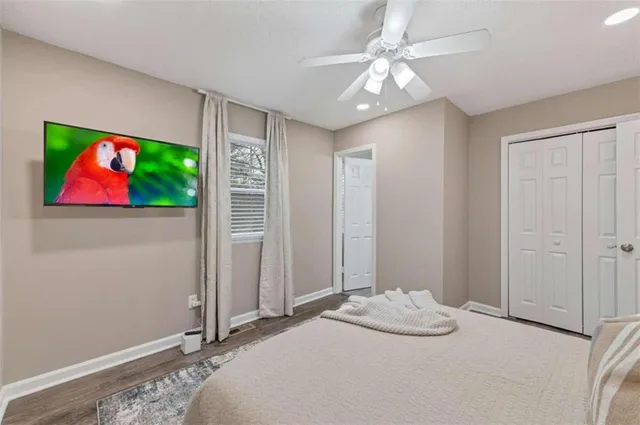 a bedroom with a bed and a painting on the wall