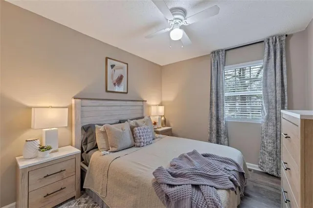 a bedroom with a large bed and a window