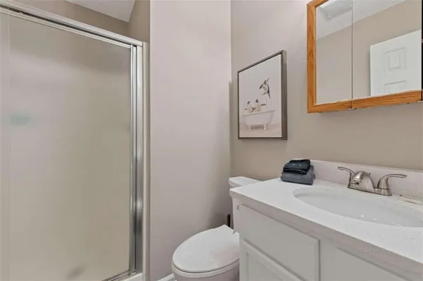 a bathroom with a sink toilet and vanity