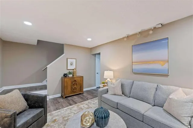 a living room with furniture and stairs