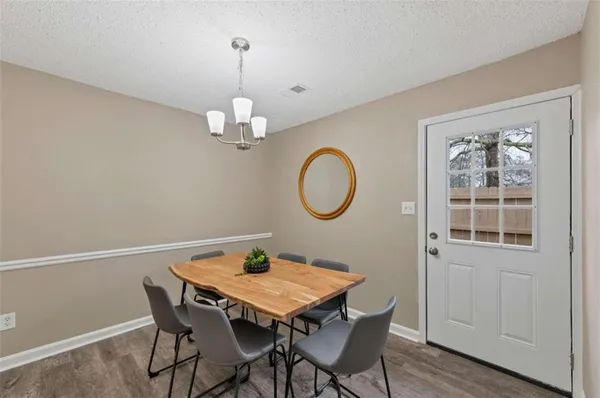 a view of a dining room with a table and chairs