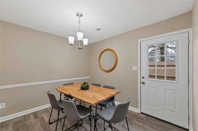 a view of a dining room with a table and chairs
