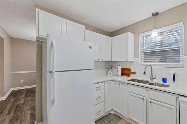a white refrigerator freezer sitting inside of a kitchen