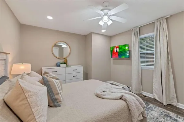 a bedroom with bed and a chandelier