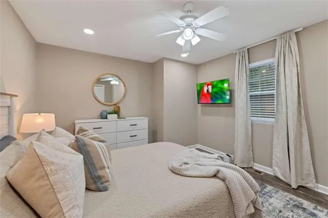 a bedroom with bed and a chandelier