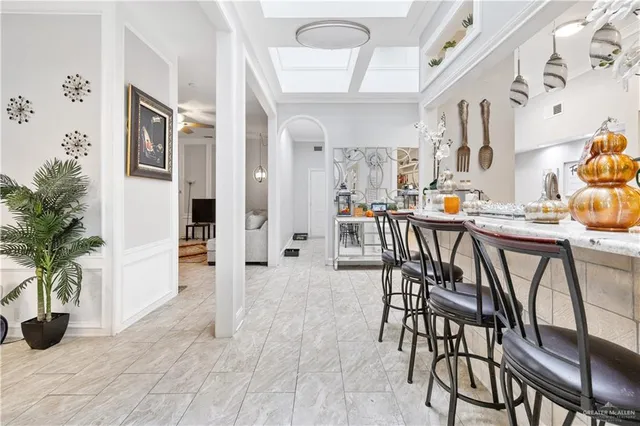 a view of a dining room with furniture and a potted plant