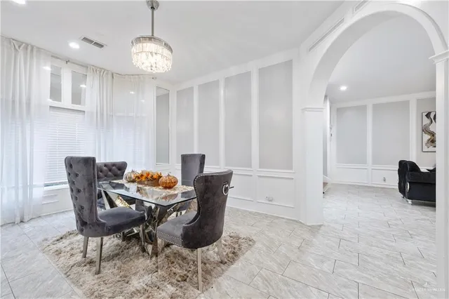a dining room with furniture and wooden floor