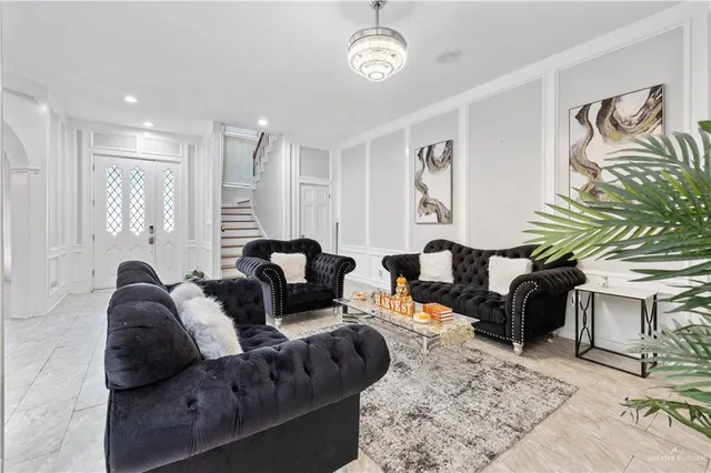 a living room with furniture potted plant and a window