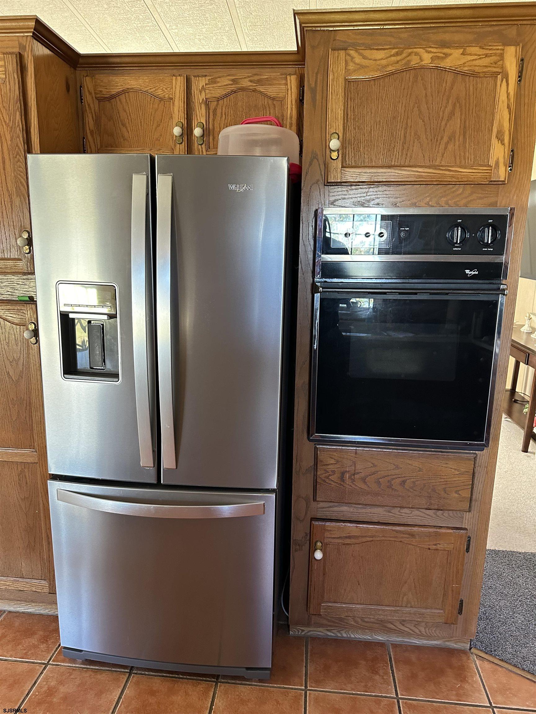 290 Mayflower Drive Buena, NJ 08310 - Photo 10 of 20 a view of a refrigerator in kitchen and an empty room