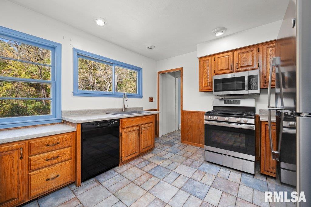 18378 Wells Ferry Road Bettendorf, IA 52722 - Photo 11 of 35 a kitchen with stainless steel appliances a stove sink and microwave