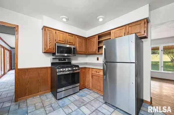 a kitchen with stainless steel appliances granite countertop a refrigerator sink and stove