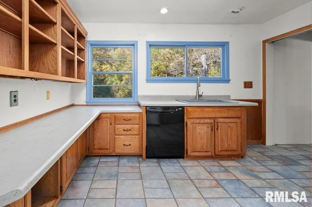 a kitchen with a stove a sink and a refrigerator