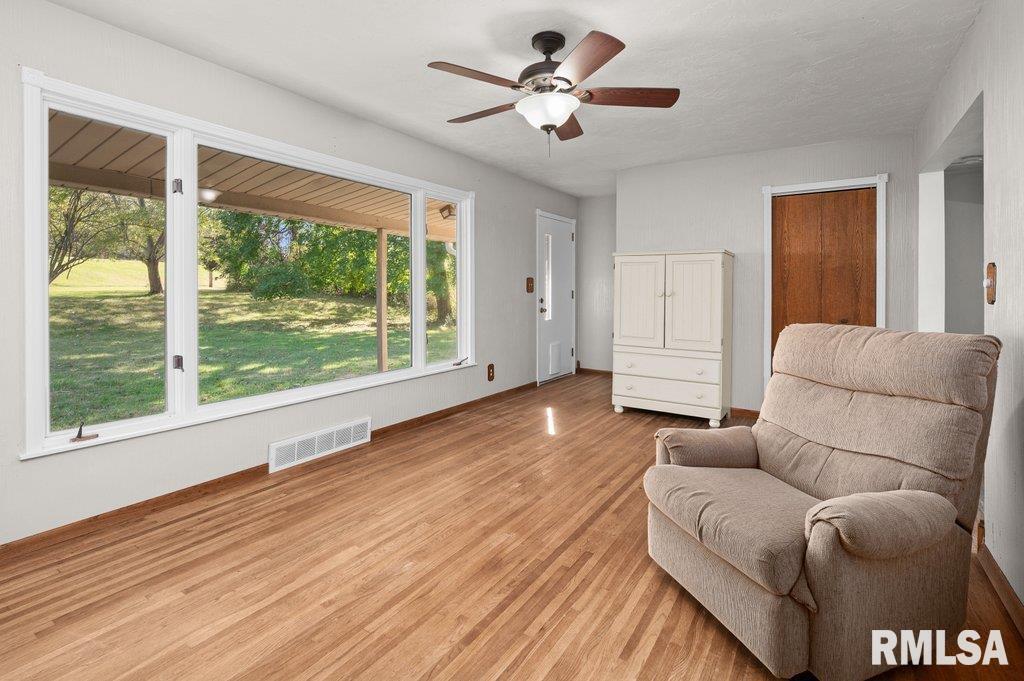 18378 Wells Ferry Road Bettendorf, IA 52722 - Photo 16 of 35 a living room with furniture and a large window with wooden floor