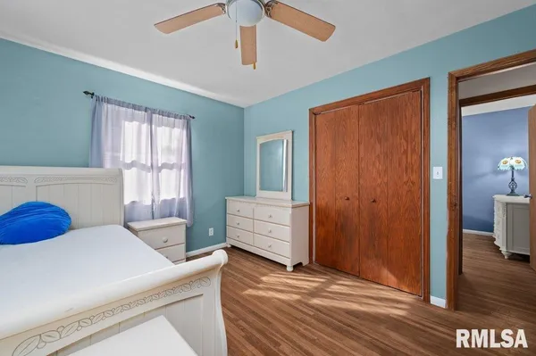 a view of a bedroom with furniture and windows