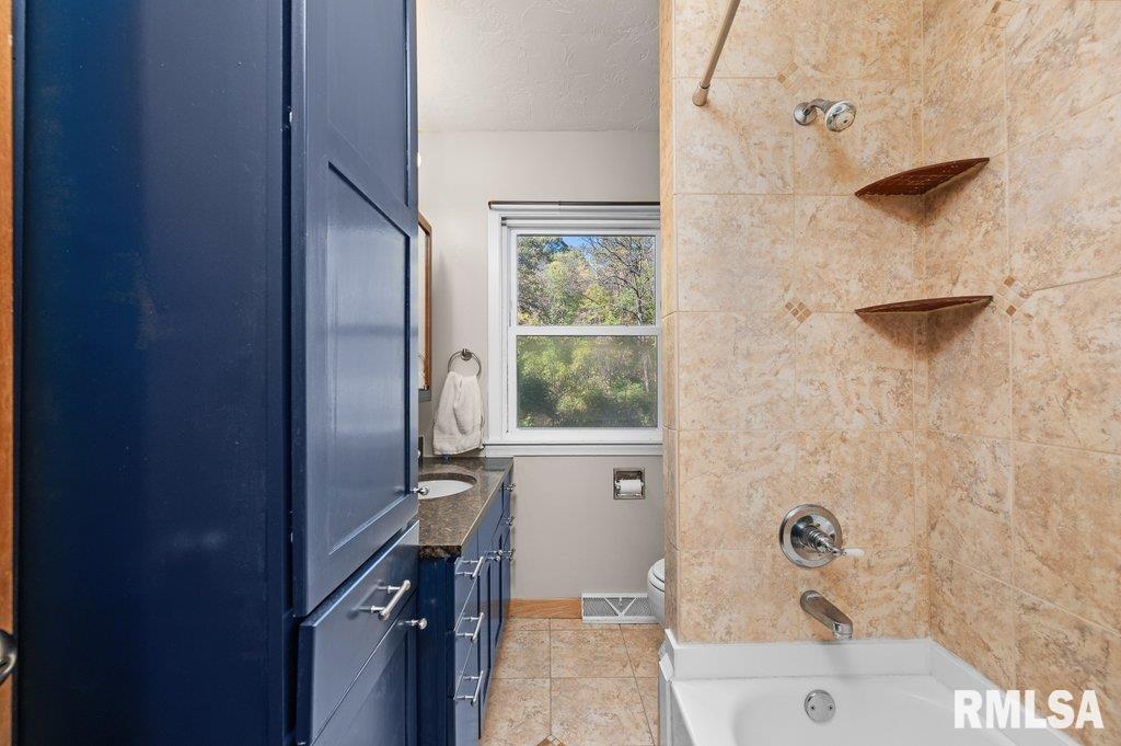 18378 Wells Ferry Road Bettendorf, IA 52722 - Photo 22 of 35 a bathroom with a bathtub and a shower