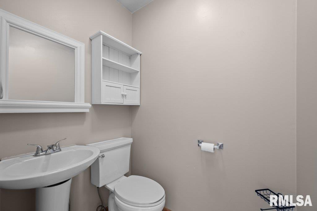 18378 Wells Ferry Road Bettendorf, IA 52722 - Photo 24 of 35 a bathroom with a sink a toilet and mirror