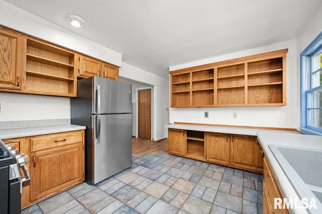 a kitchen with stainless steel appliances granite countertop a refrigerator and a sink