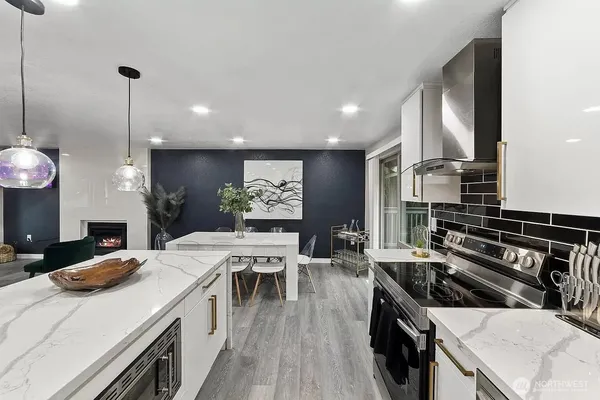 a kitchen with stove and chairs
