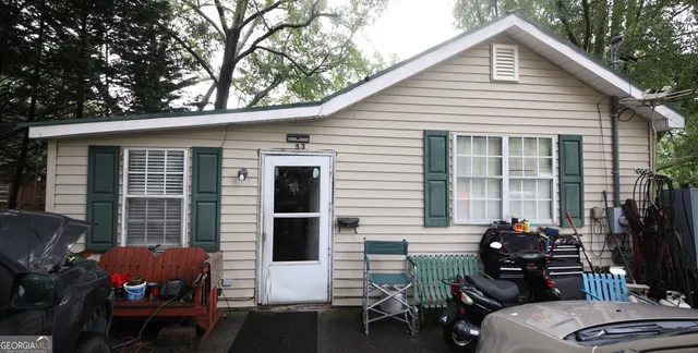 a backyard of a house with table and chairs