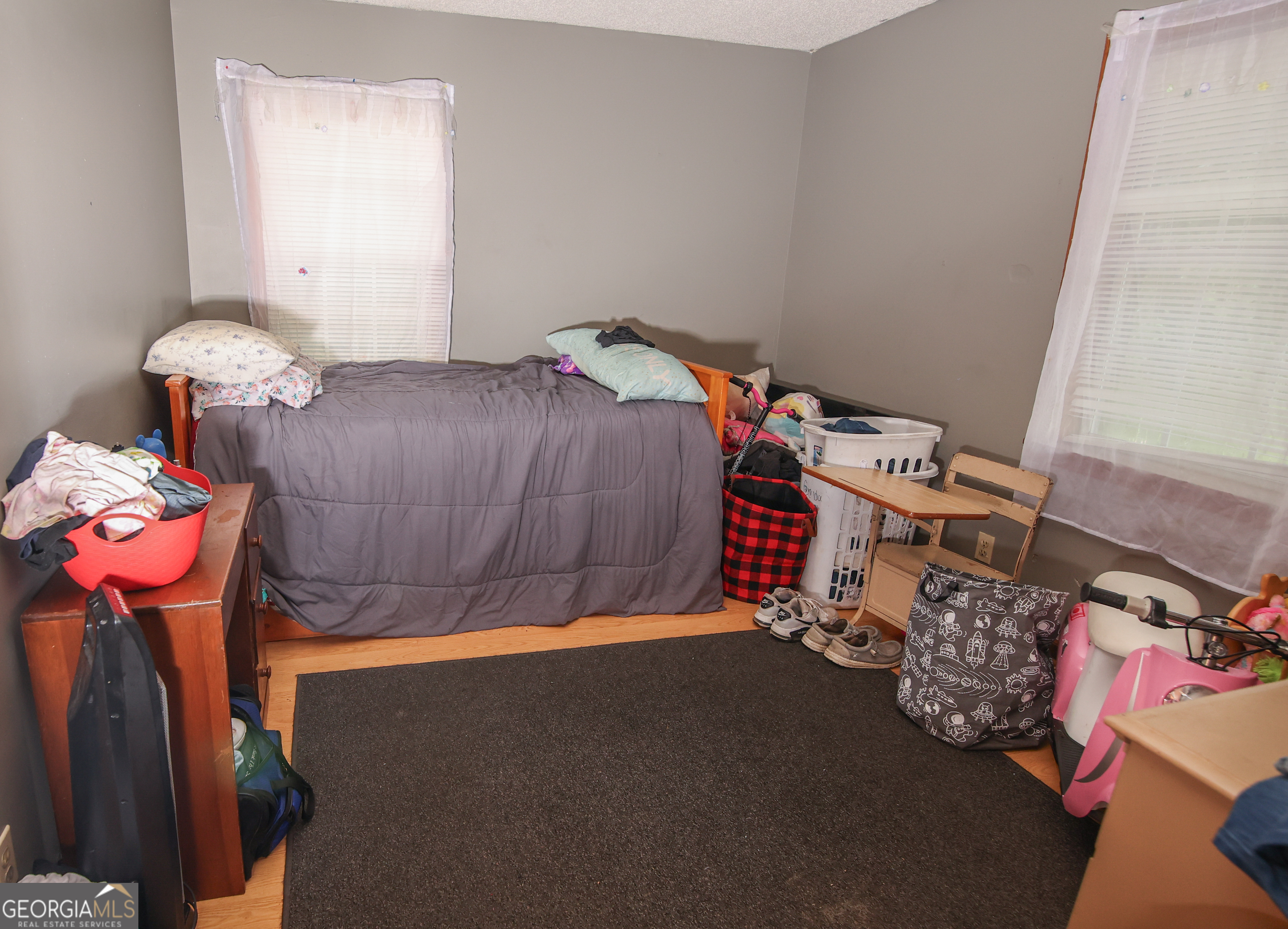 51 Busha Street Toccoa, GA 30577 - Photo 7 of 12 a bedroom with a bed and a chandelier