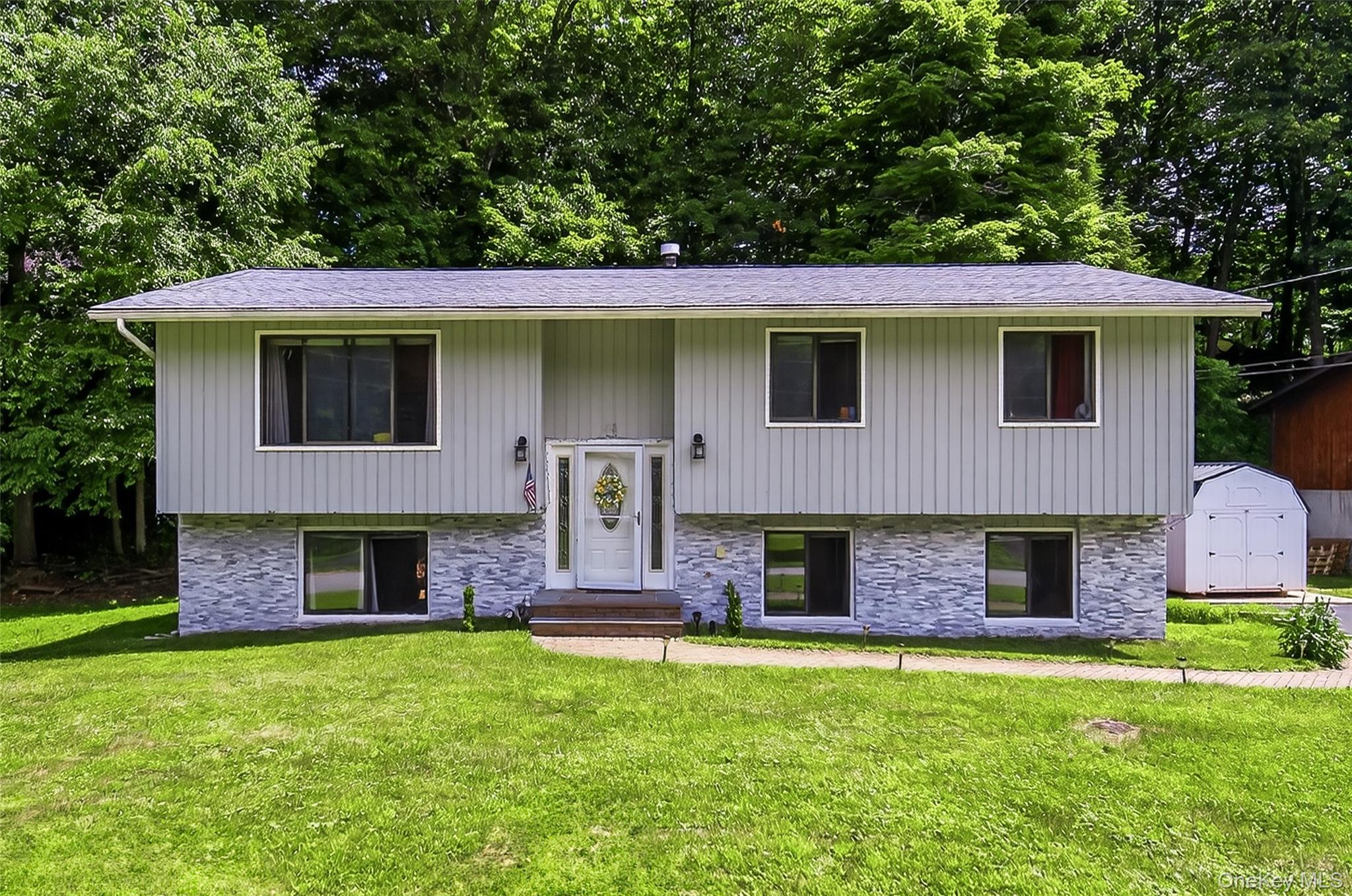 49 Raker Road Poughkeepsie, NY 12603 - Photo 1 of 1 Bi-level home featuring entry steps, a storage unit, and a front lawn