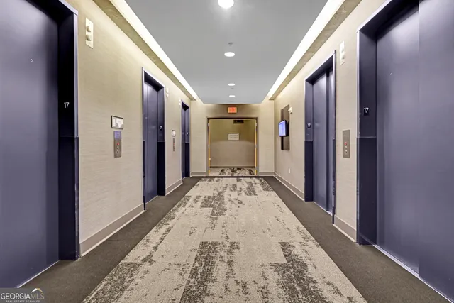 a view of hallway with wooden floor