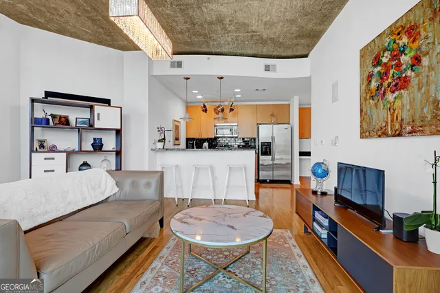 a living room with furniture and a wooden floor