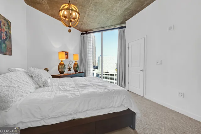 a bedroom with a bed and a large window